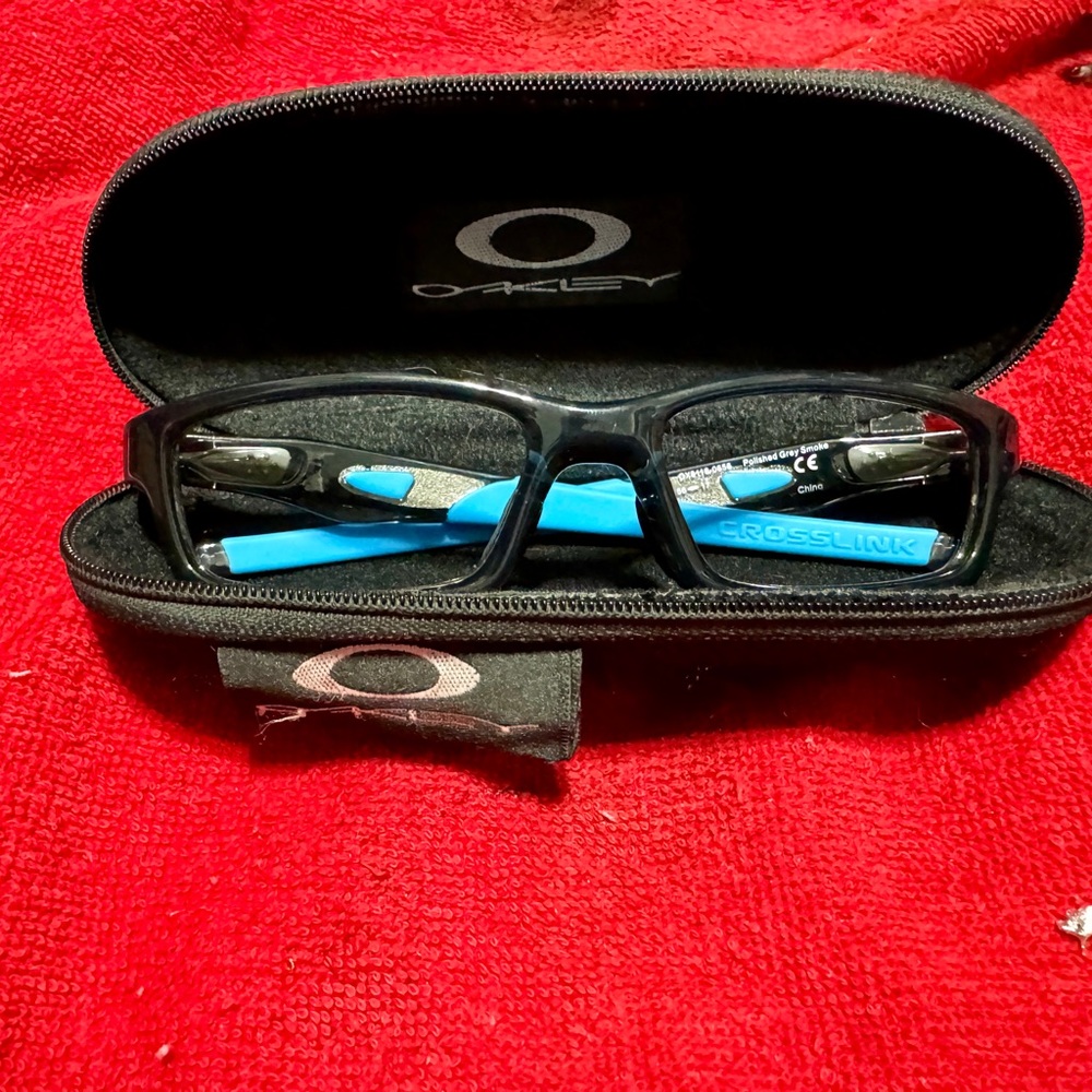 Oakley Crosslink in Smoked Gray with blue temples.